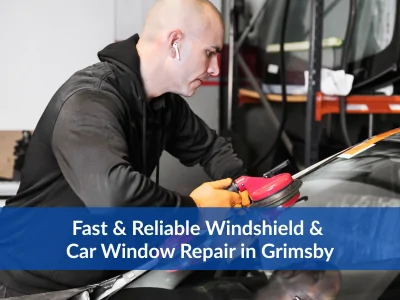 Auto glass technician repairing a windshield in Grimsby